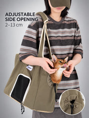 Cat peeking through the adjustable side head opening of a Chestnut Brown shoulder tote.