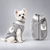Gray and white fleece dog coat shown on a seated terrier and beside the dog.