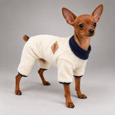 Dog wearing the Warm Ivory casual fleece jumpsuit, standing in side view.