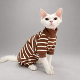 Cat wearing the Caramel Brown Cocoa Stripe onesie, seated in side view.