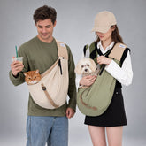 Cat in a cream nylon sling and small dog in an olive green sling, worn crossbody by two people.