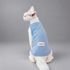 Cat wearing the Light Blue Powder Cloud vest, seated in rear view.