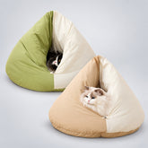 Two cats resting inside green-and-cream and beige-and-cream burrowing cat beds with triangular enclosed shapes.