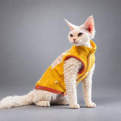 Cat seated in the Golden Yellow waffle fleece vest, viewed from the side.
