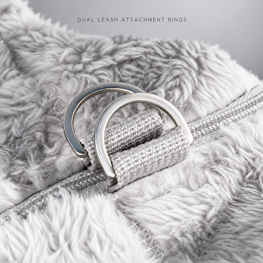 Dual metal leash attachment rings secured beside the back zipper.