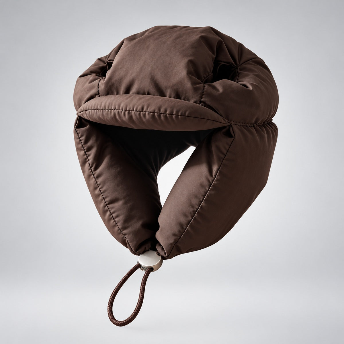 Front view of the brown padded dog hat with a short brim, side flaps and adjustable chin cord.