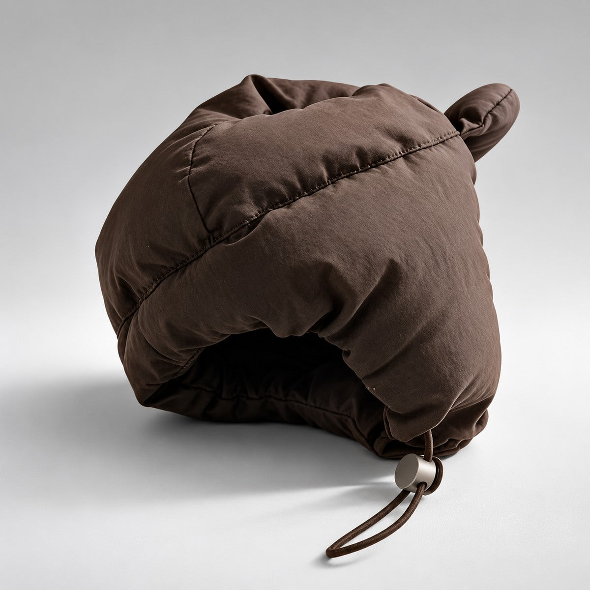 Rear view of the padded dog hat showing panel seams and the adjustable drawcord.