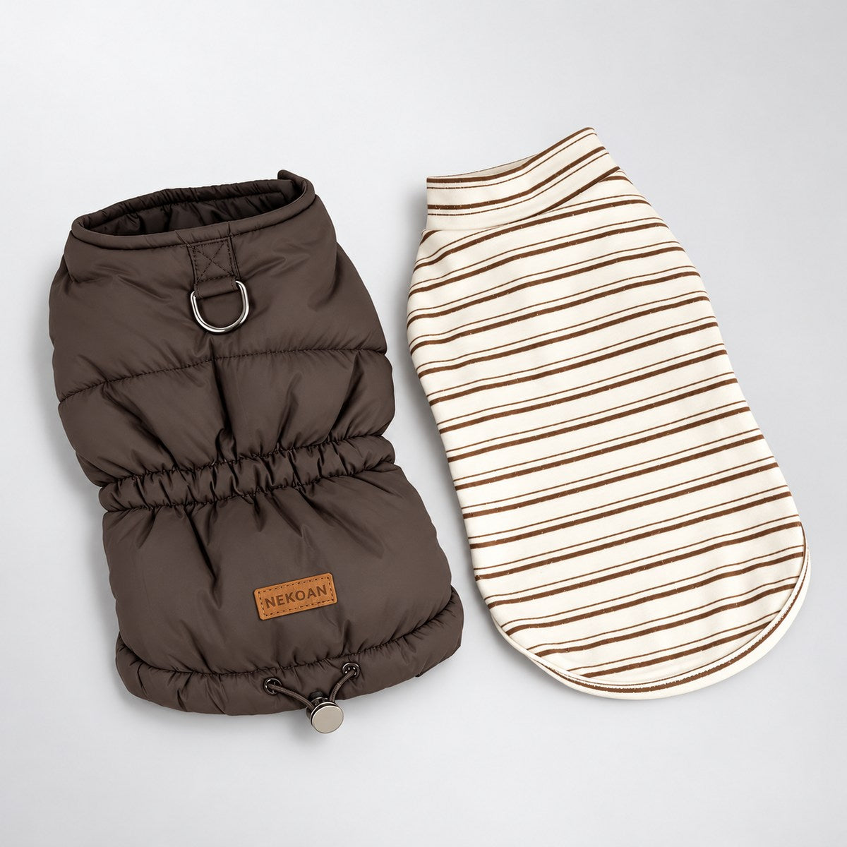 Two-piece dog outfit laid flat: a brown padded vest with back D-ring beside a separate cream and brown striped shirt.