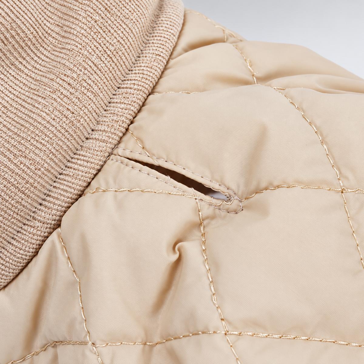 Collar and leash access opening near the quilted coat neckline