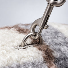 Close-up of a leash clipped to the back ring on the Blue plaid dog coat.