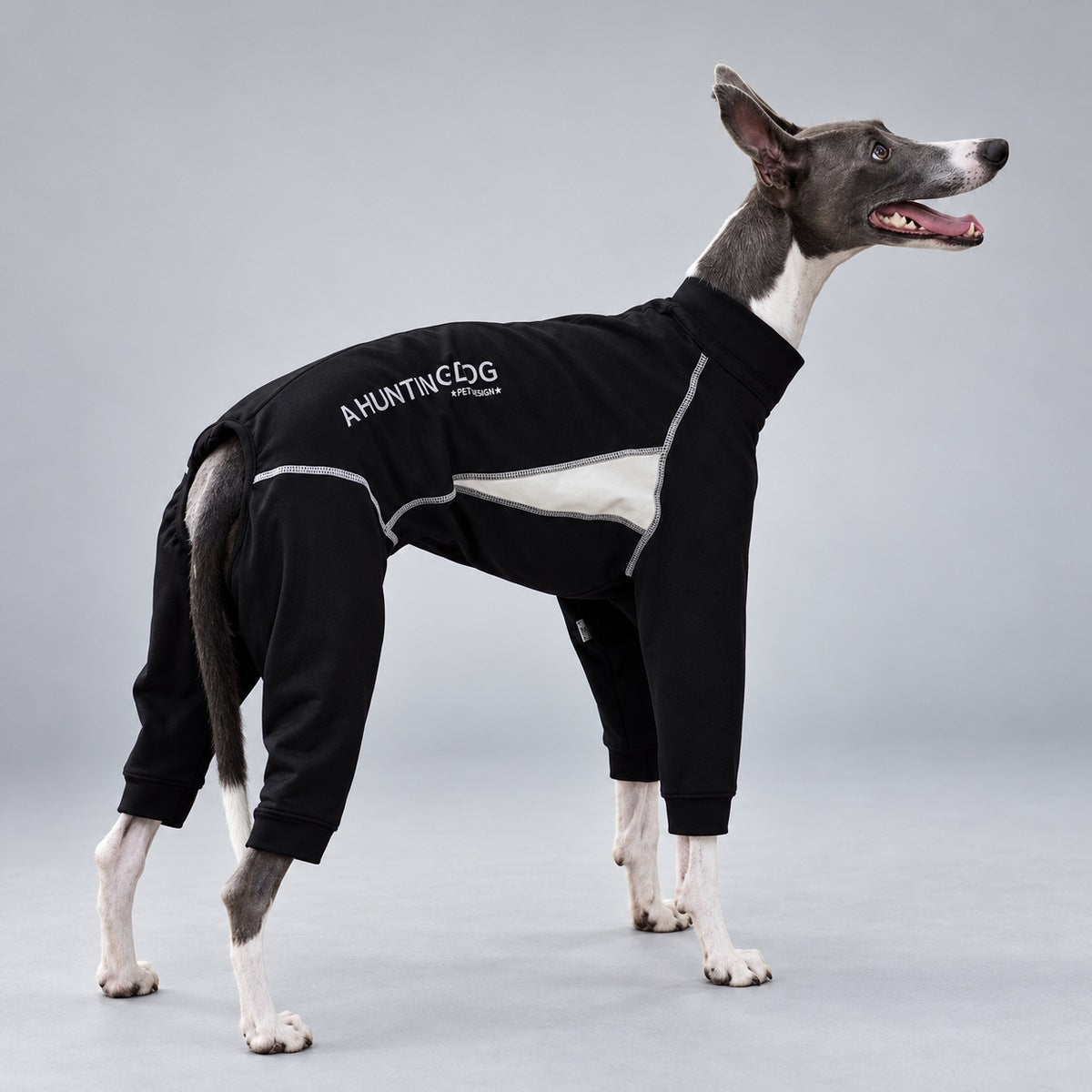 Side view of the black and ivory sighthound snowsuit with contrast stitching and fitted leg cuffs.