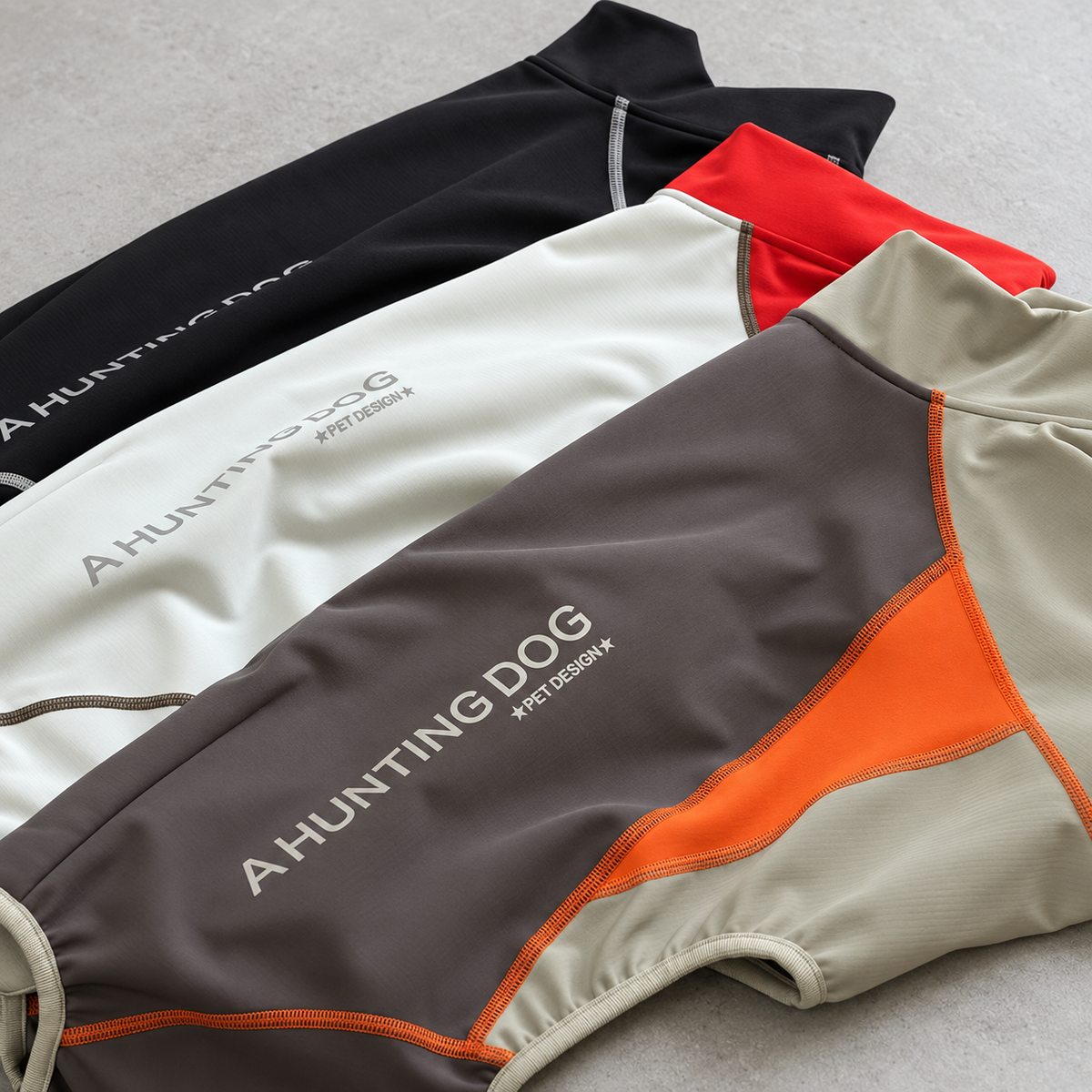 Close-up of the colour-block panels, contrast stitching and fabric texture across the three snowsuit colourways.