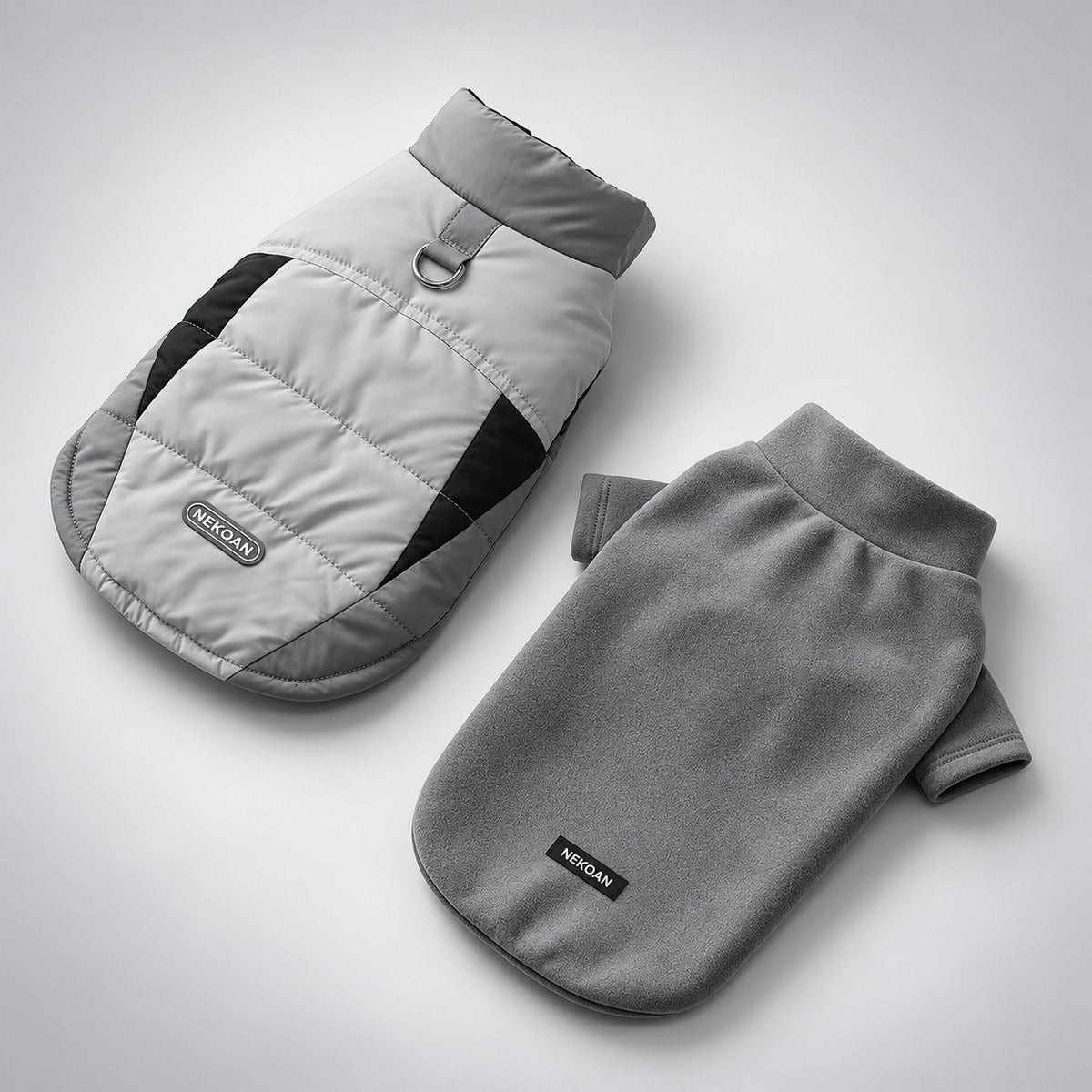 Gray padded dog vest and separate fleece shirt displayed side by side.