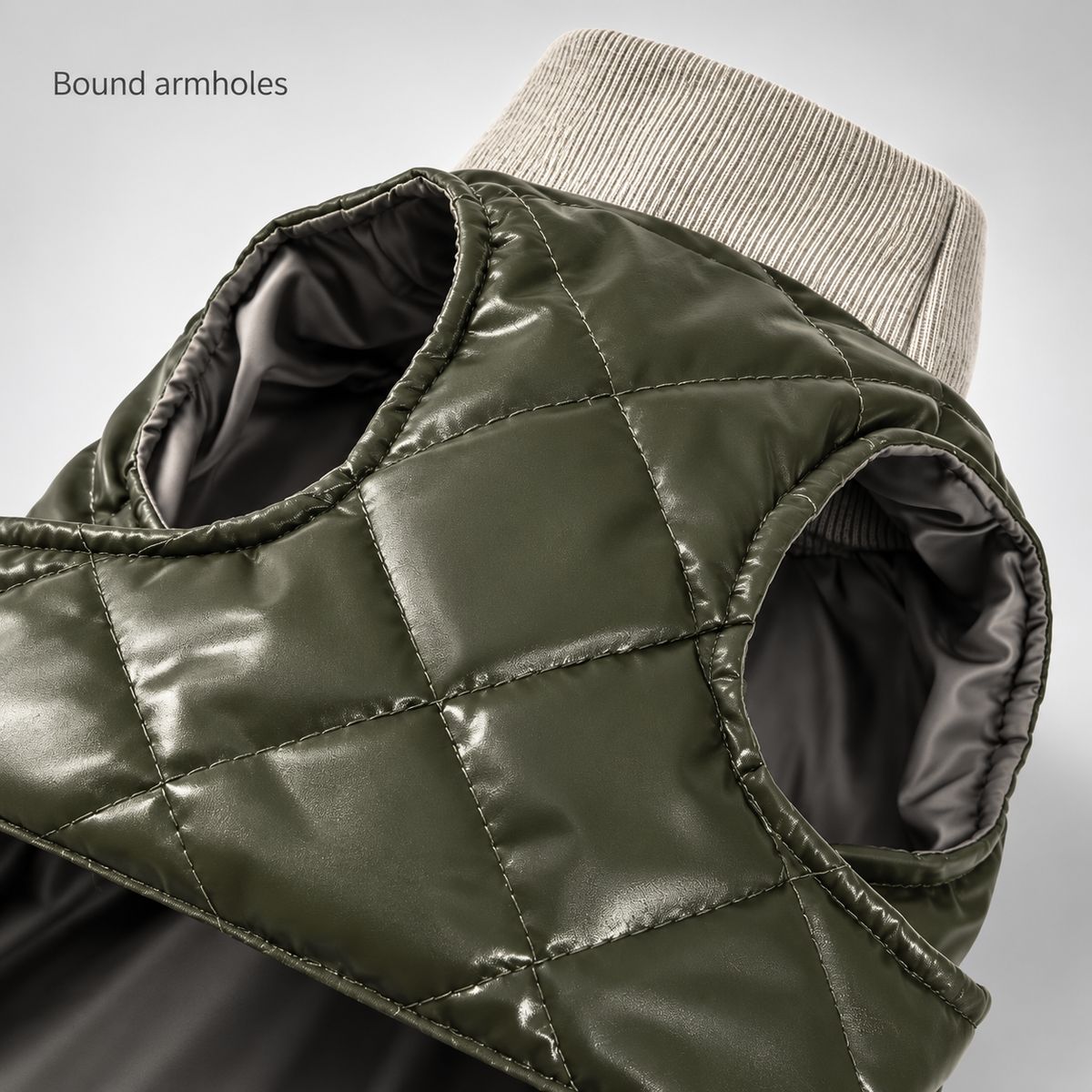 Close-up of the bound arm openings, dark lining and contrasting knit collar.