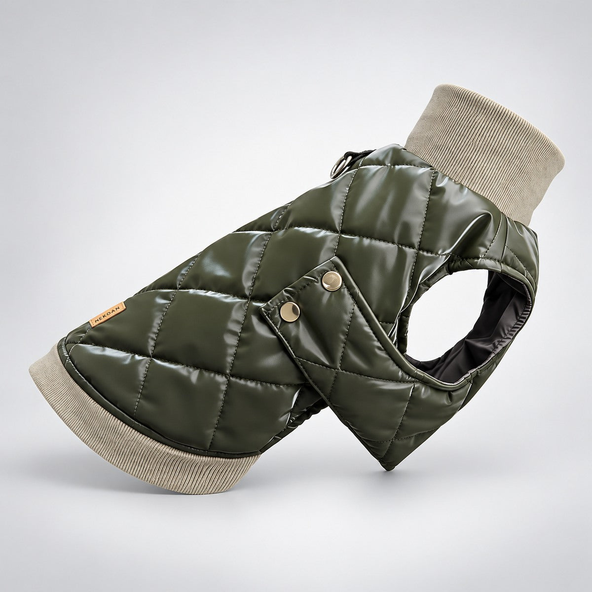 Angled view of the padded olive dog vest with diamond quilting and gold-tone side snaps.