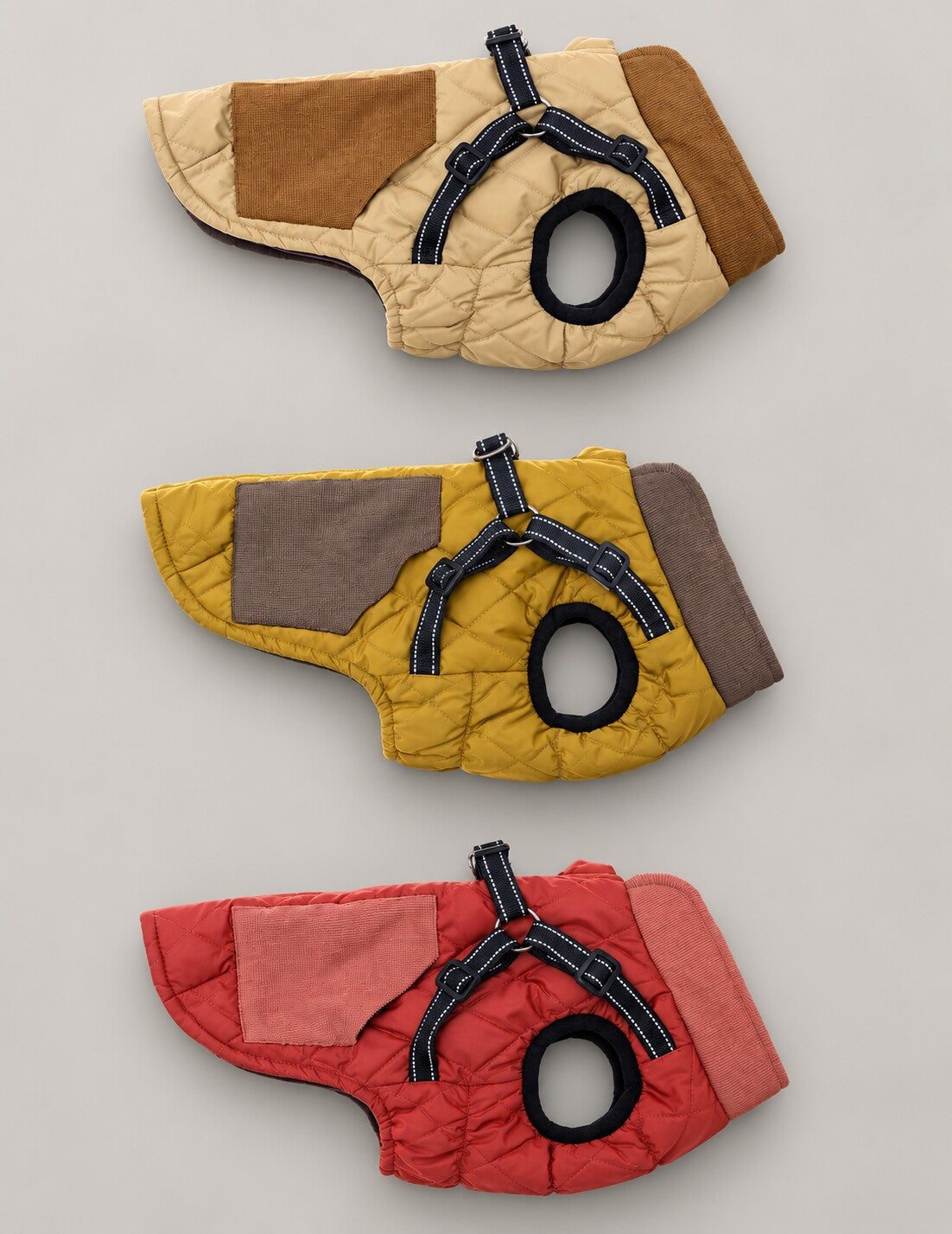 Side views of the quilted harness dog coat in Beige, Mustard and Rose gold, showing the sleeveless shape.