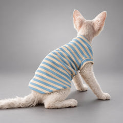 Cat wearing the Muted Blue & Cream Stripe Sky & Cream vest, seated in rear view.