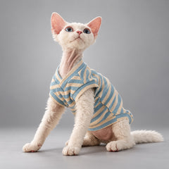Cat wearing the Muted Blue & Cream Stripe Sky & Cream vest, seated in side view.
