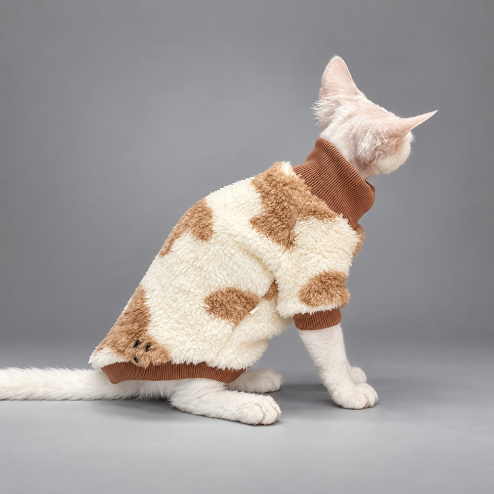 Cat wearing the Cream & Caramel Teddy Cozy pajamas, seated in rear view.