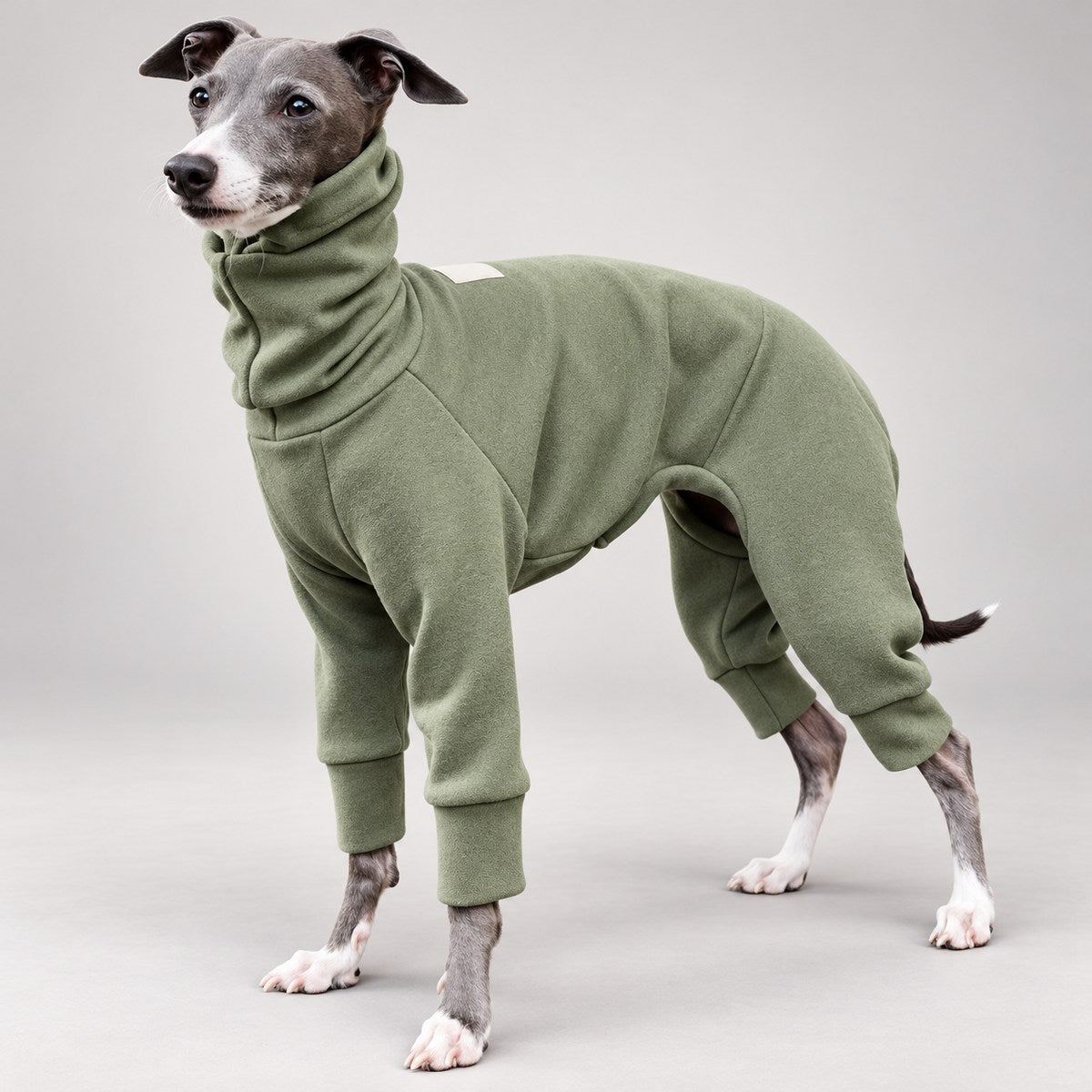Side view of the sage green four-leg sighthound onesie, showing the contoured body and fitted cuffs.