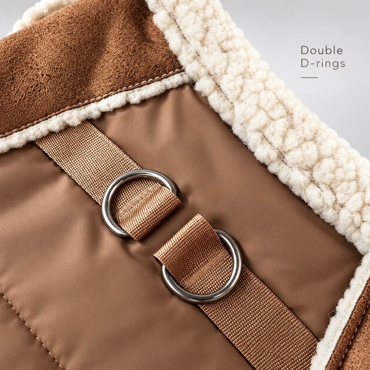 Close-up of the double leash rings on the Brown faux suede puffer vest.