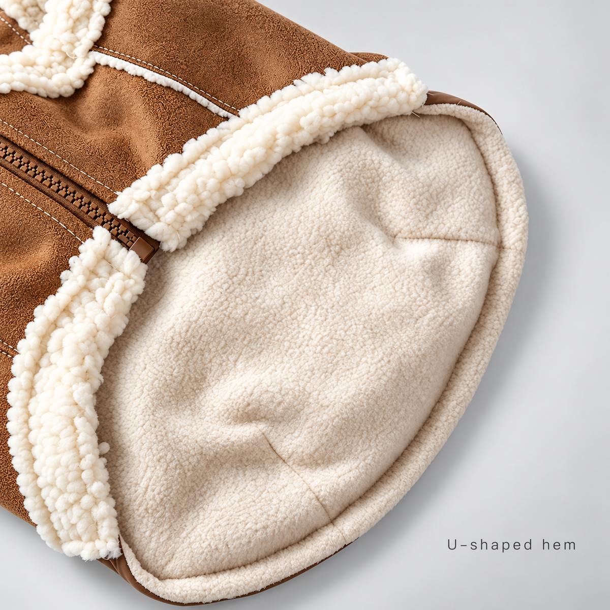 Inside view of the Brown puffer vest showing the curved hem and lining.