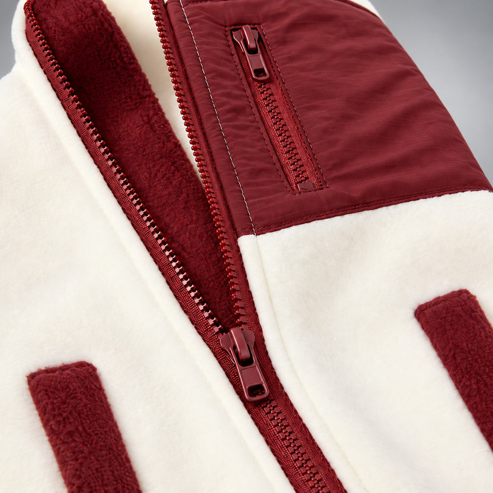 Close-up of the Cream & Burgundy workwear vest showing the zipper and pocket trim.