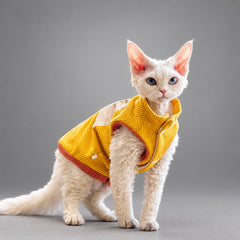 Cat wearing the Golden Yellow waffle fleece vest, seated in side view.