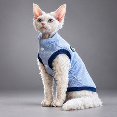 Cat wearing the Nordic Blue waffle fleece vest, seated facing the camera.