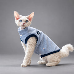 Cat wearing the Nordic Blue waffle fleece vest, standing in side view.